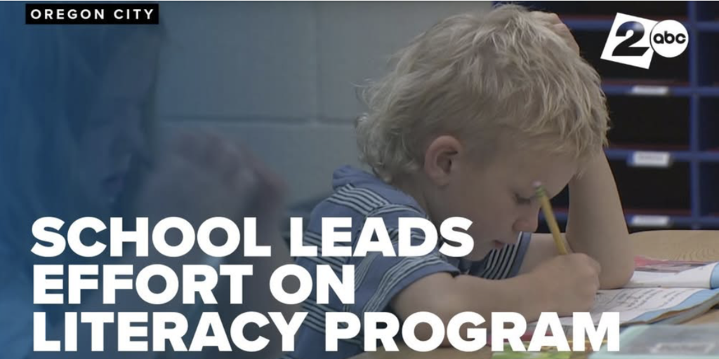 School Leads Effort on literacy Program with elementary student writing with a pencil in a workbook