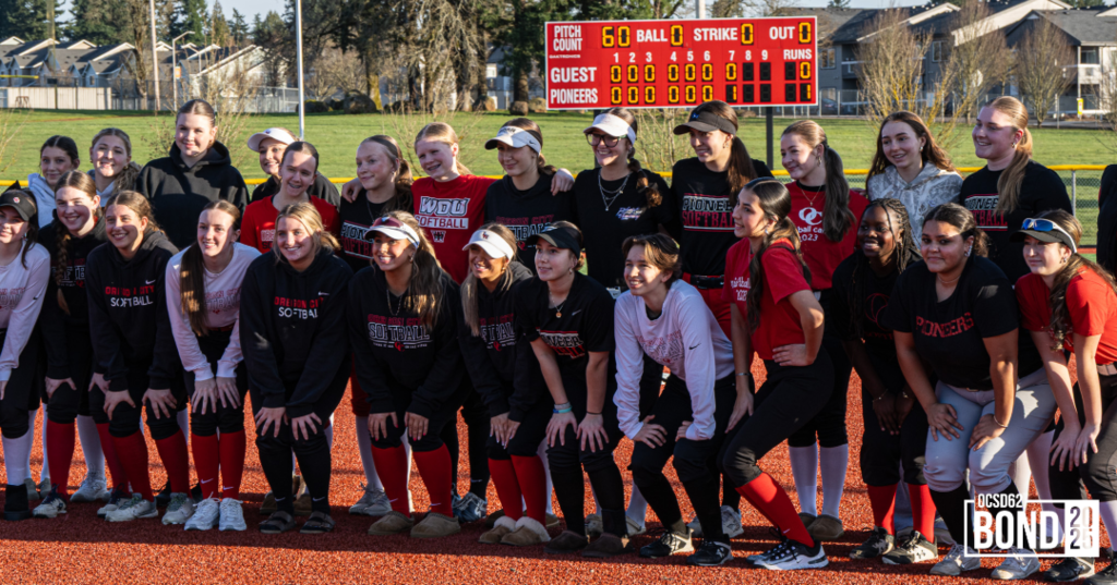 Softball Players standing and smiling in a group