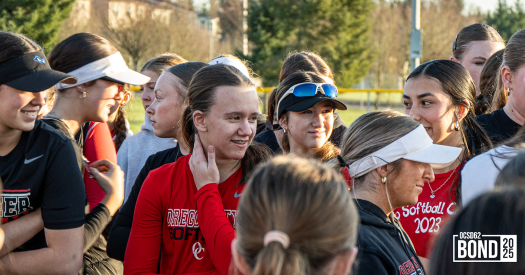 Softball Players standing and smiling in a group