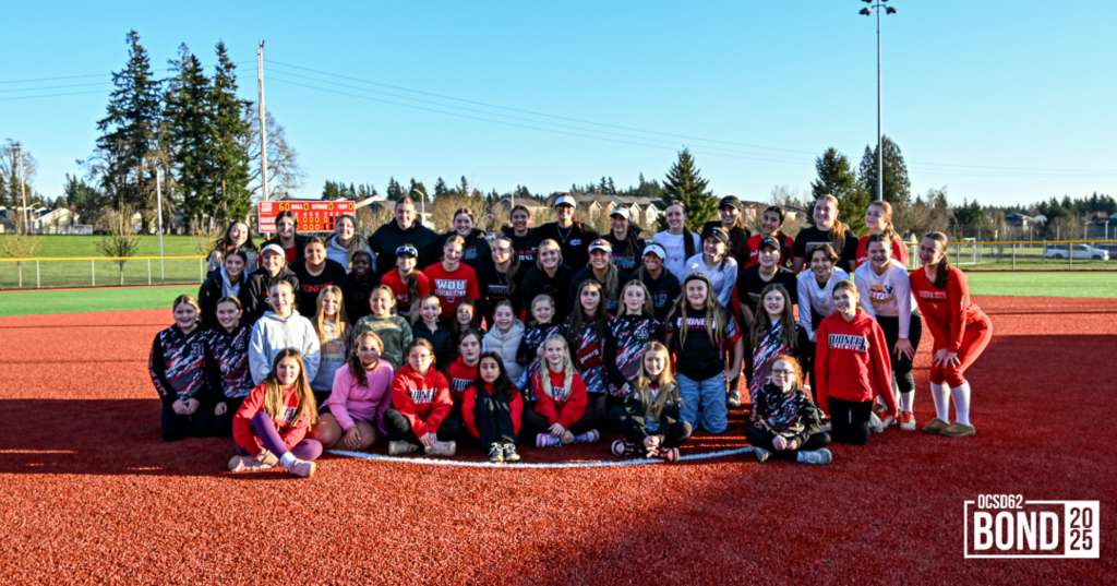 Softball Players standing and smiling in a group