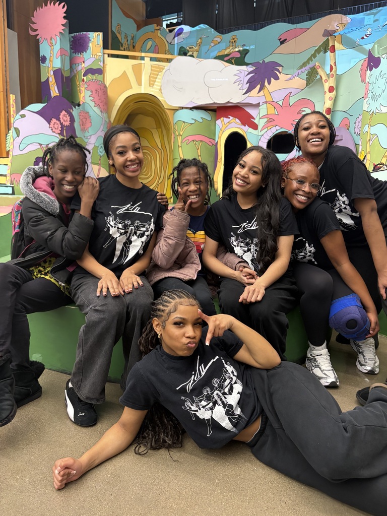 Dancers posing with 2 students