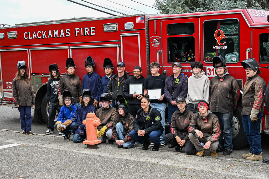 CAIS Students posing with Clackamas Fire in front of a fire truck