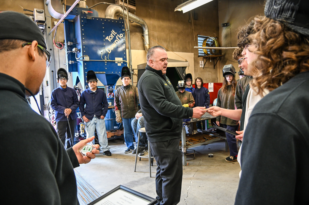 Blake being awarded a challenge coing by the fire inspector