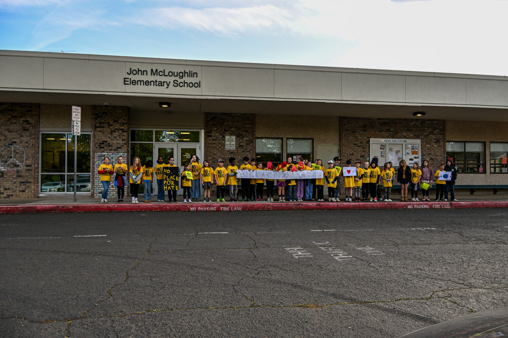 JME Students wearin yellow shirts and holding a banner that says "No Place for Hate"