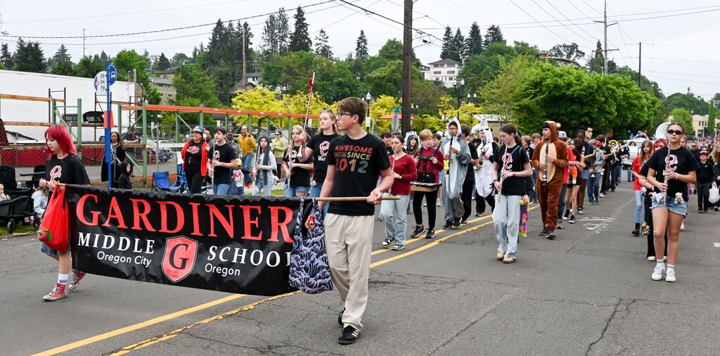 Gardiner Middle School banner in parade with band