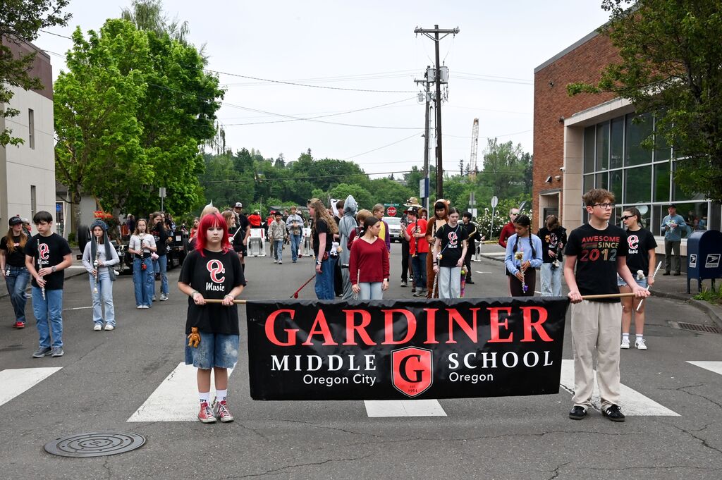 Gardiner Middle School banner in parade with band