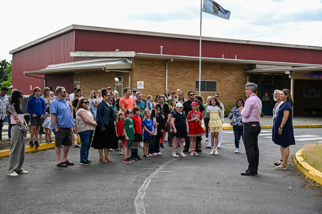 The Candy Lane community gathers in front of the school as a speaker addresses the crowd at the groundbreaking ceremony.