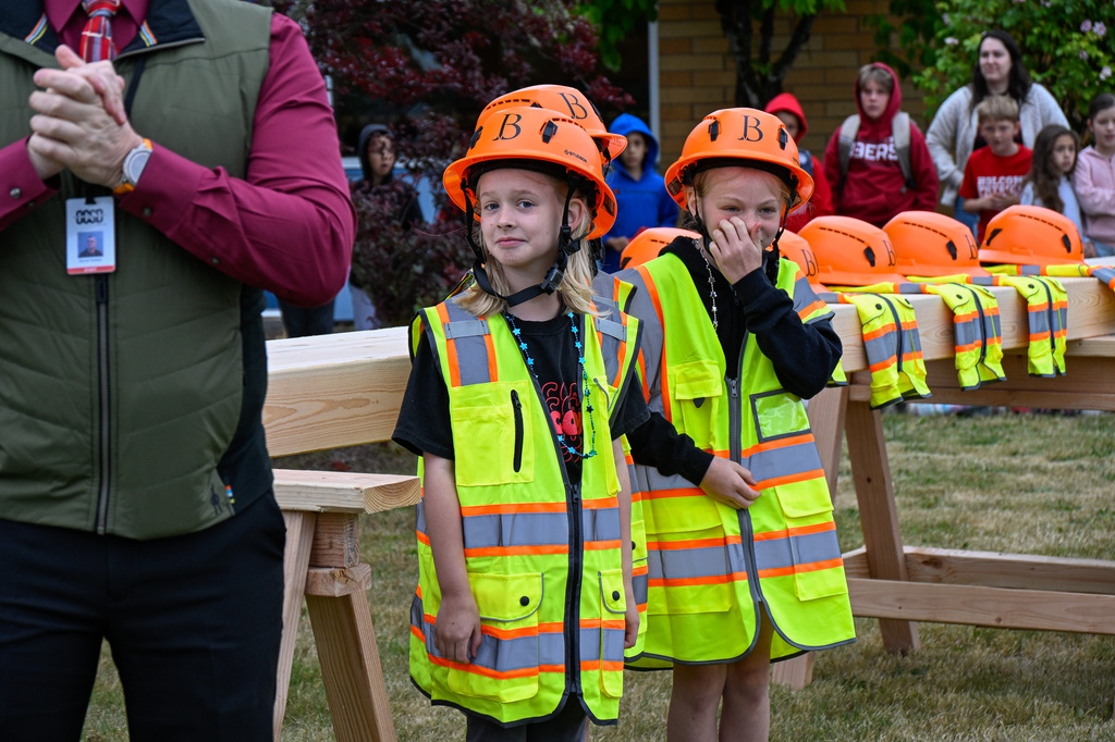 Three female students with hard hats and vests on
