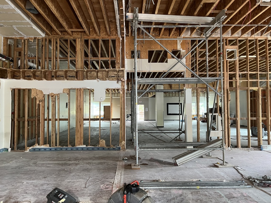 Large room under construction. Scaffolding stands in the middle of the room.