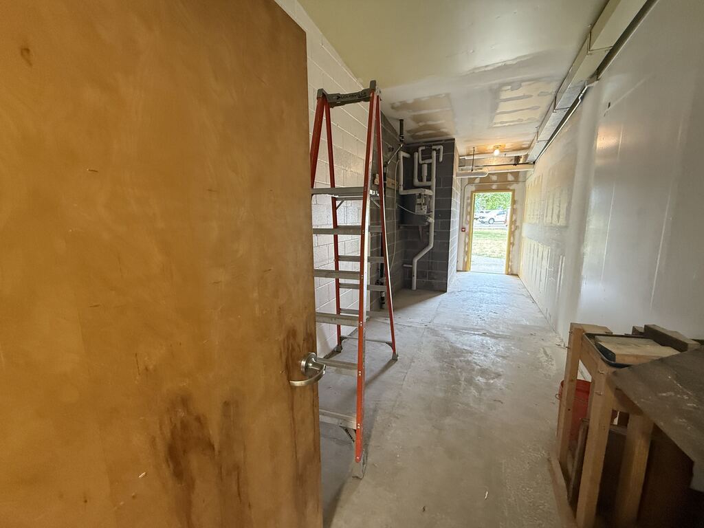 Room with ladder and open door on the other side.