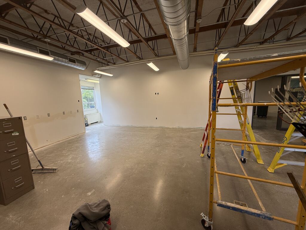 Room under construction with ladder and scaffolding.