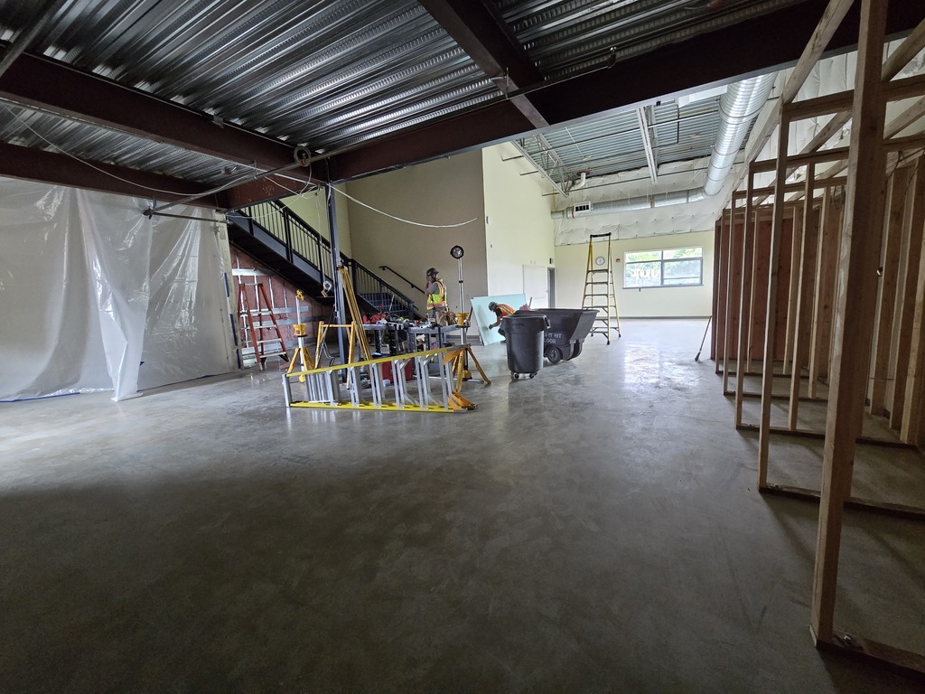 A room under construction showing wood framing and some construction equipment.