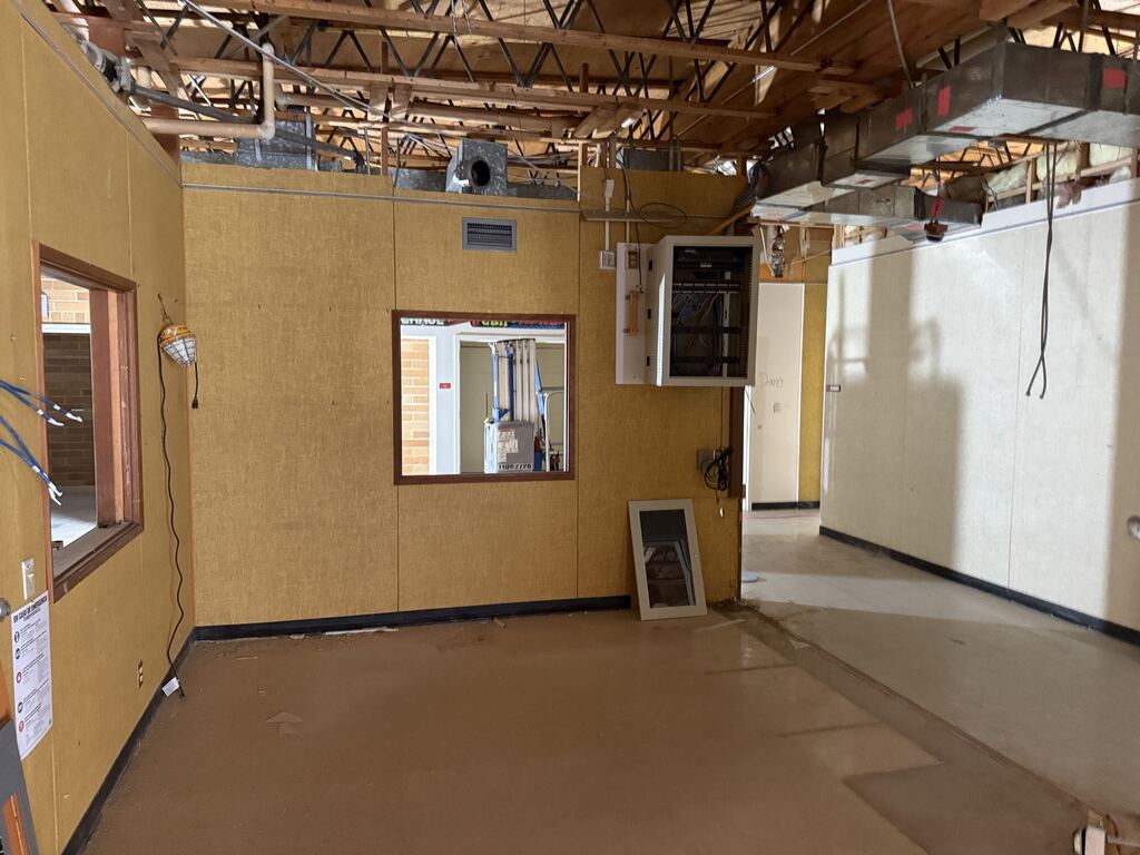 Room under construction with exposed ceiling.