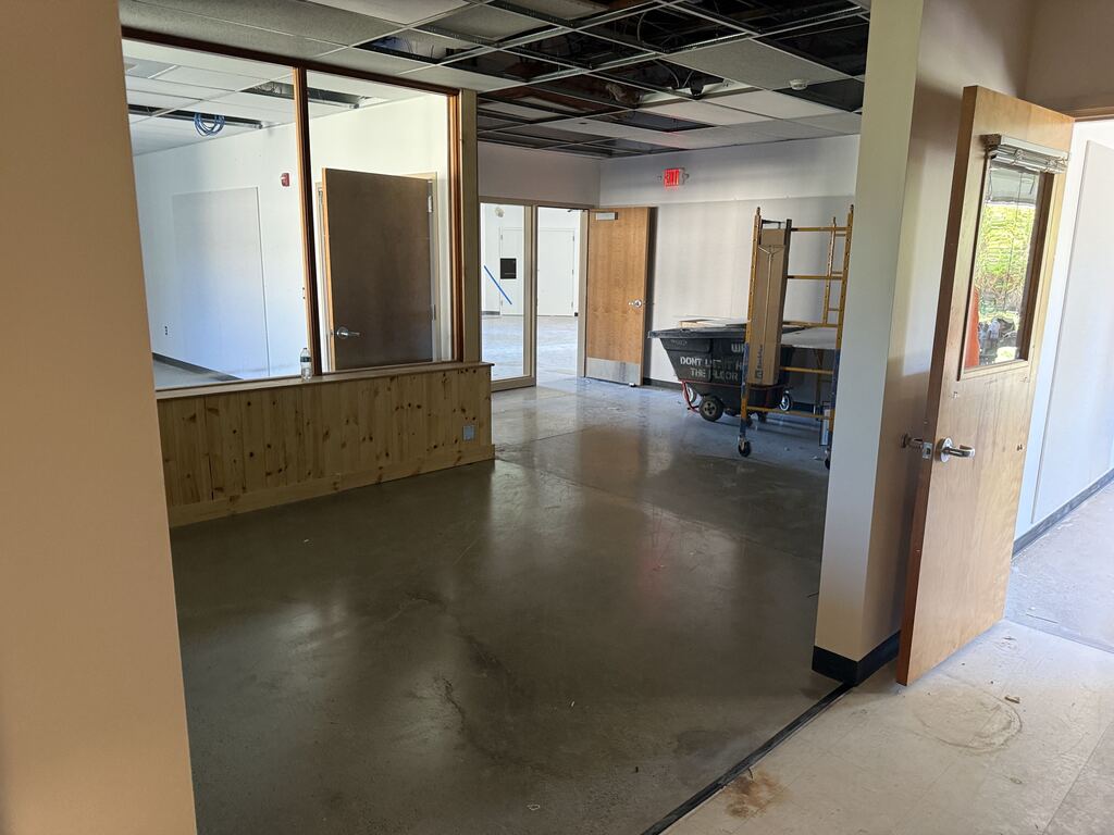 An area under construction with some doors opened and scaffolding.