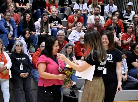 Elizabeth receiving award and flowers at event