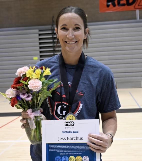 Jess standing with award certificate and flowers