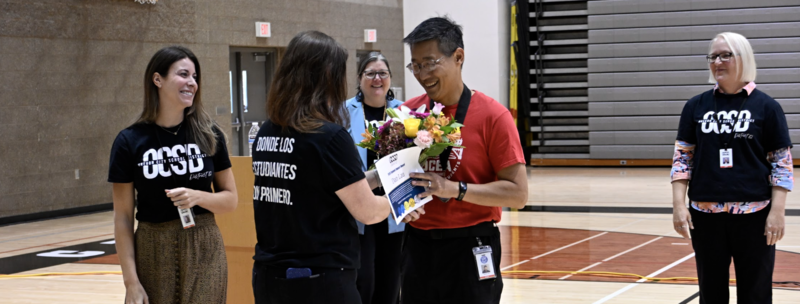 Dan recieves flowers and award 