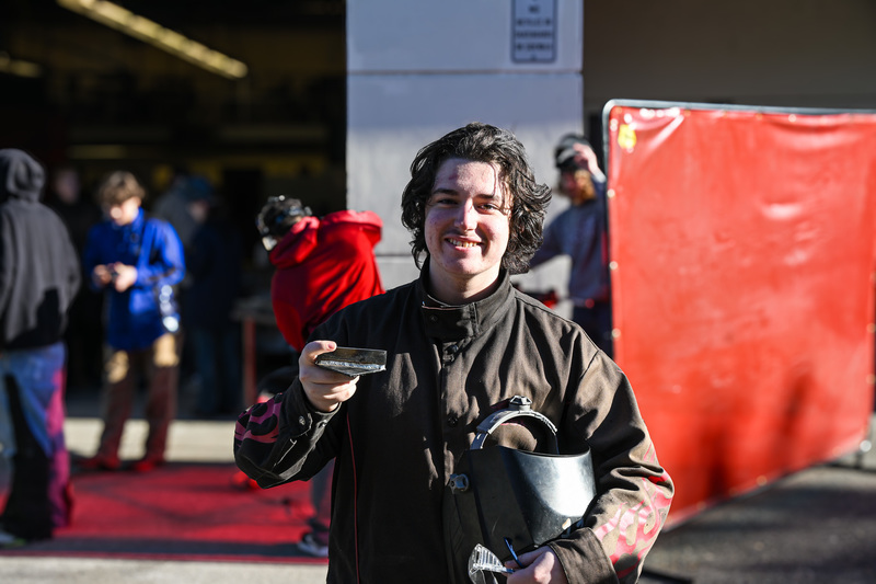 CAIS Student holding welding project