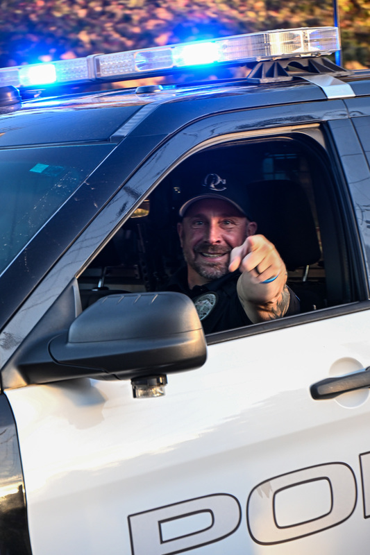 Officer Shockley pointing at camera from car