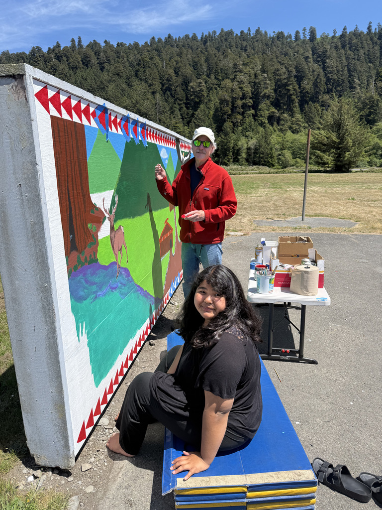 Carissa and her teacher, Mr. Ross working on the mural.