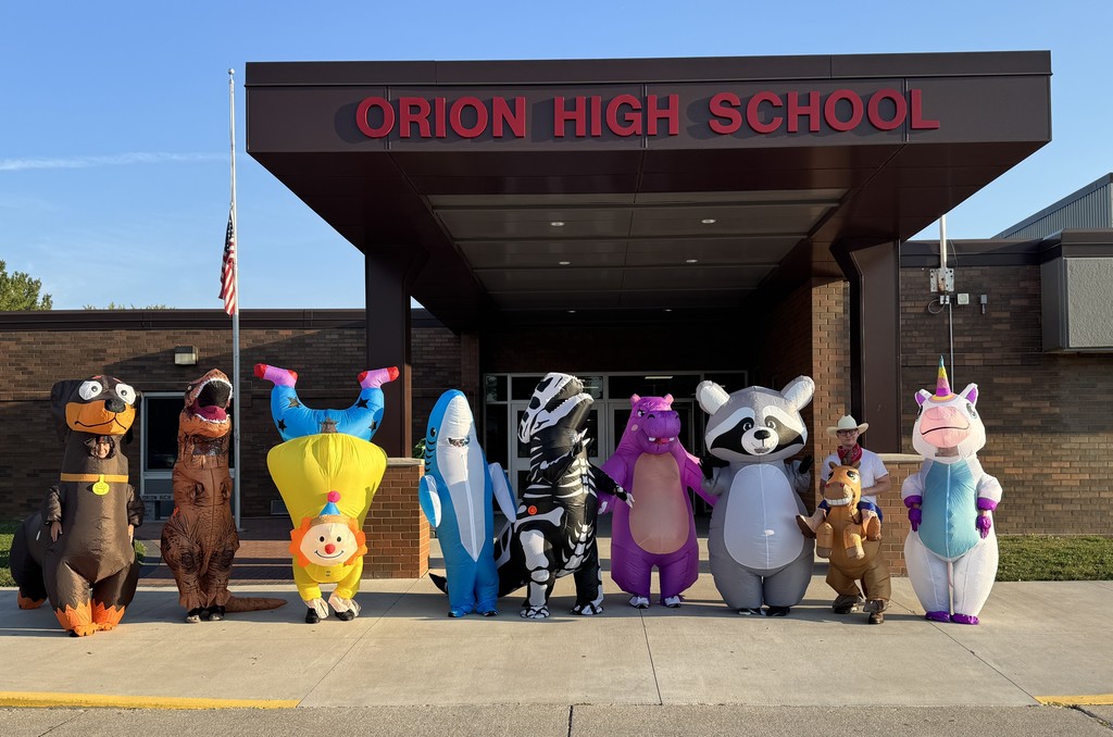 inflatable costumes lined up outside of school