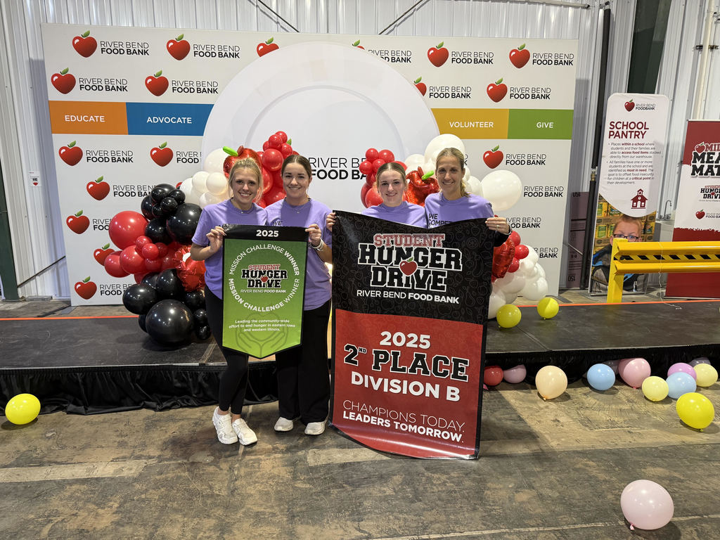 three students and the Student Council Sponsor pose with their banner awards