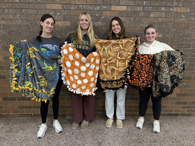 students holding blankets