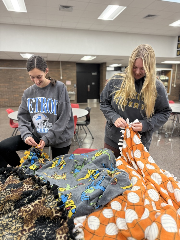 students tying blankets