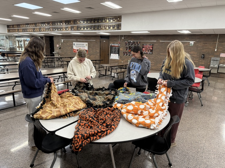 students tying blankets