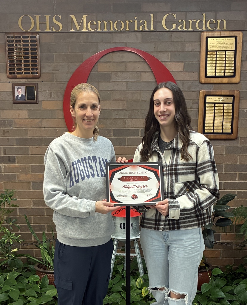 Mrs. Nightingale presenting Abigail her January Student of the Month certificate.