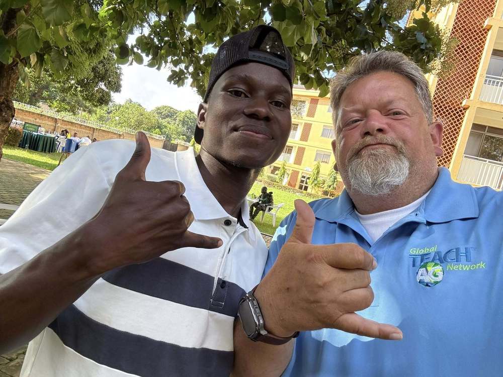 Two men doing hand gestures in front of school