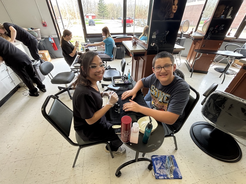 Student receiving a manicure