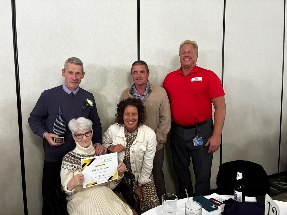 Jeff Keller with award and family and principal