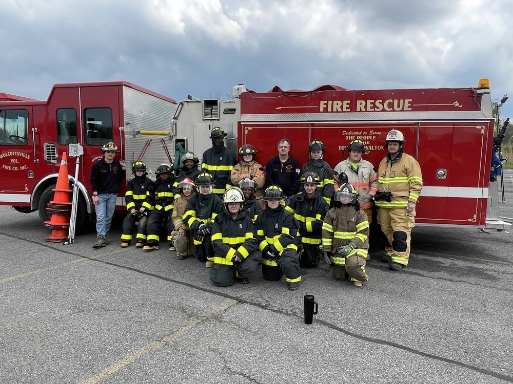 Students and firefighters in front of fire truck