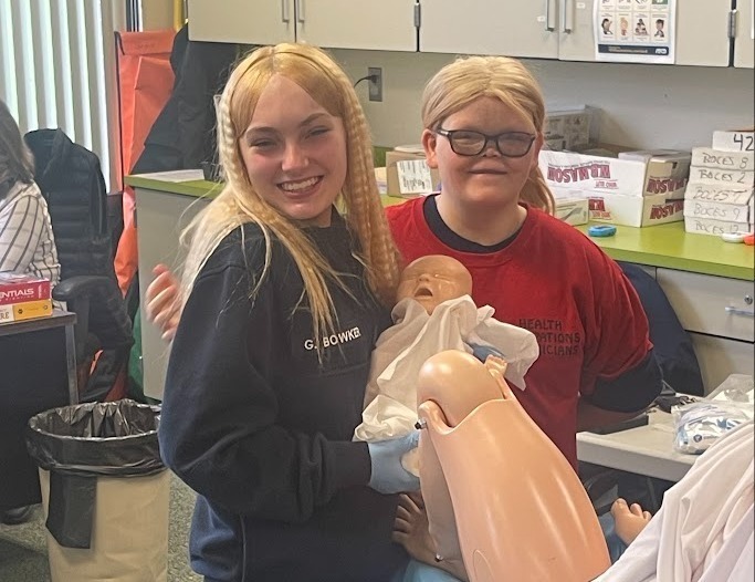 Two student with manikin and fake baby