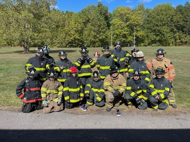 Students posing in firefighter gear