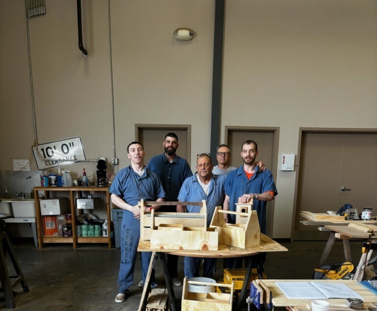 Students and teacher pose with toolboxes