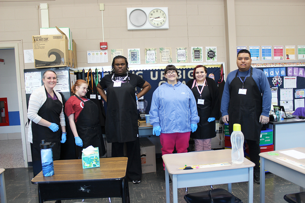 teacher and students in front of coffee station