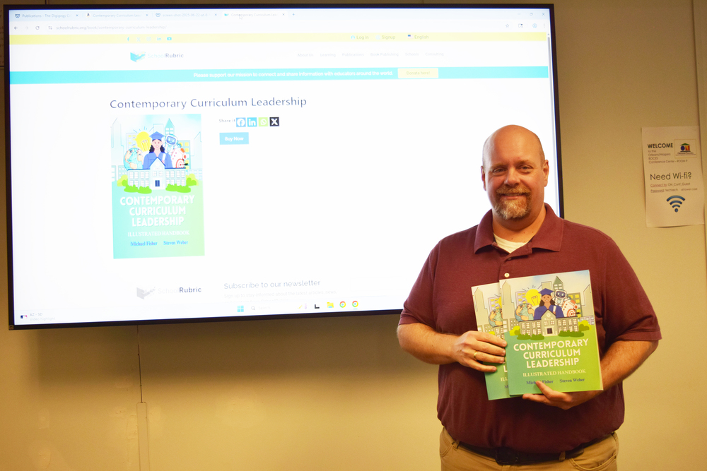 Man standing in front of screen and holding two books