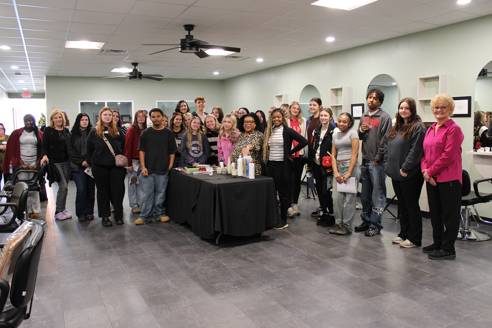 Group of students and teachers standing in hair salon