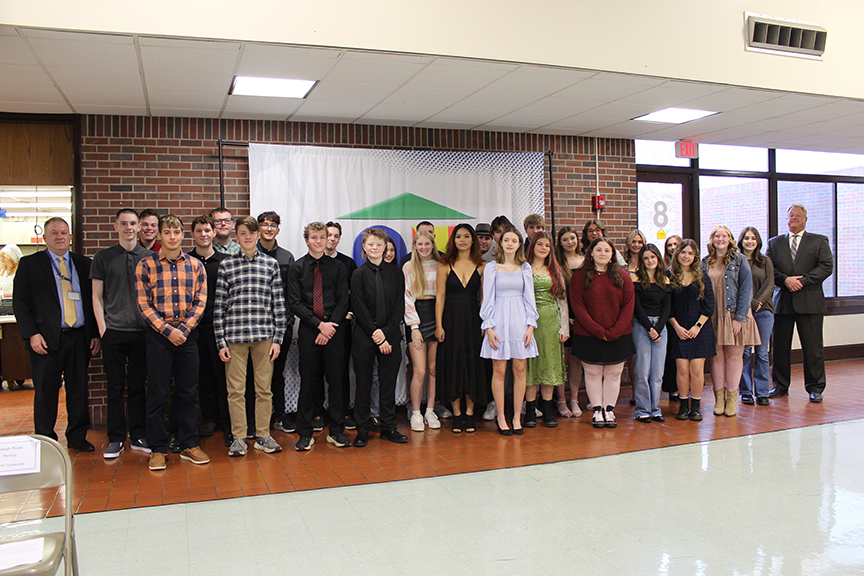 Administrators standing with national technical honor society students