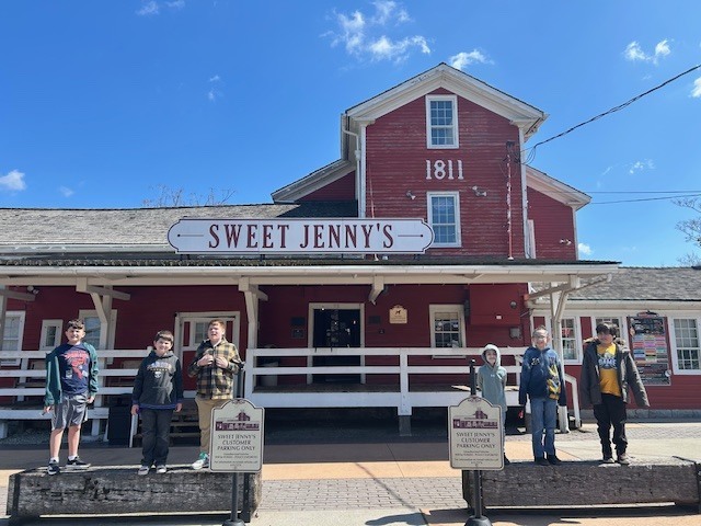 Six students in front of Sweet Jenny's store