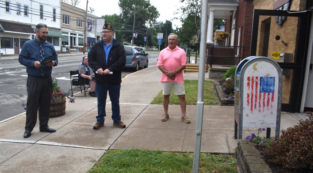 Teacher talking to American Legion rep at mailbox
