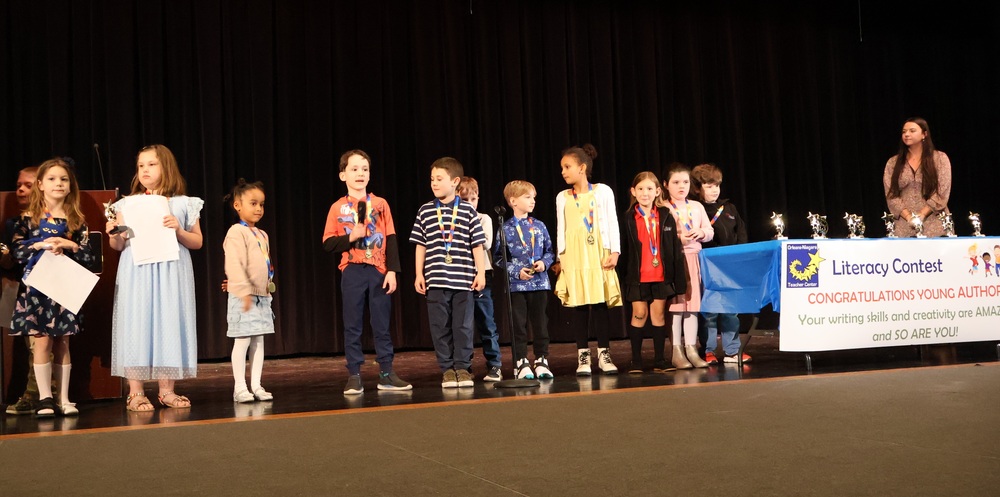 Students on stage getting literacy awards