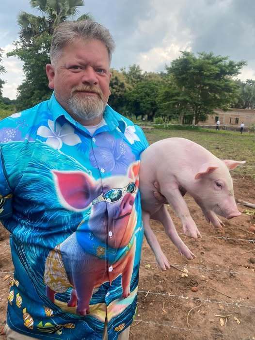 Man holding pig