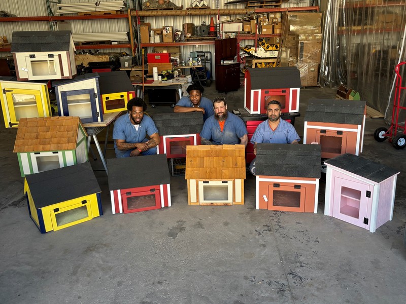 Students showing off little libraries and food pantries they built