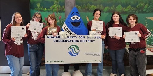 Six students with mascot holding certificates