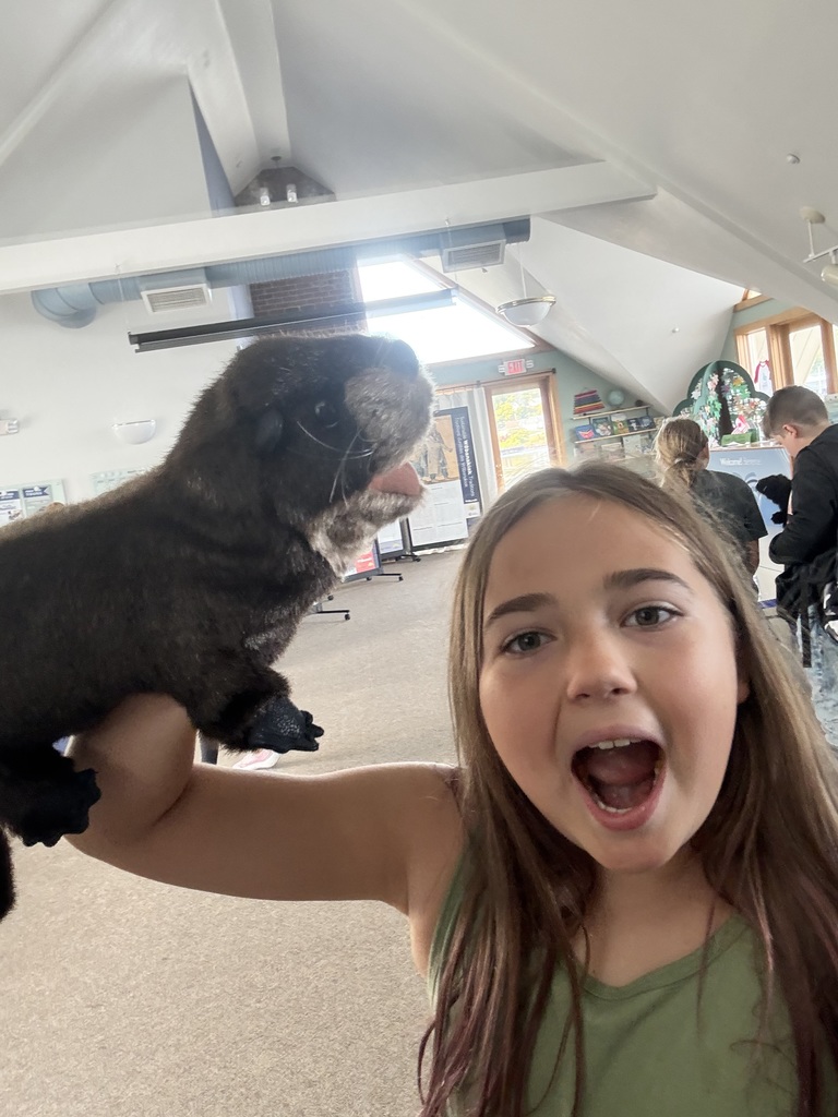 5th grade girl holding an otter puppet on the Northern Star