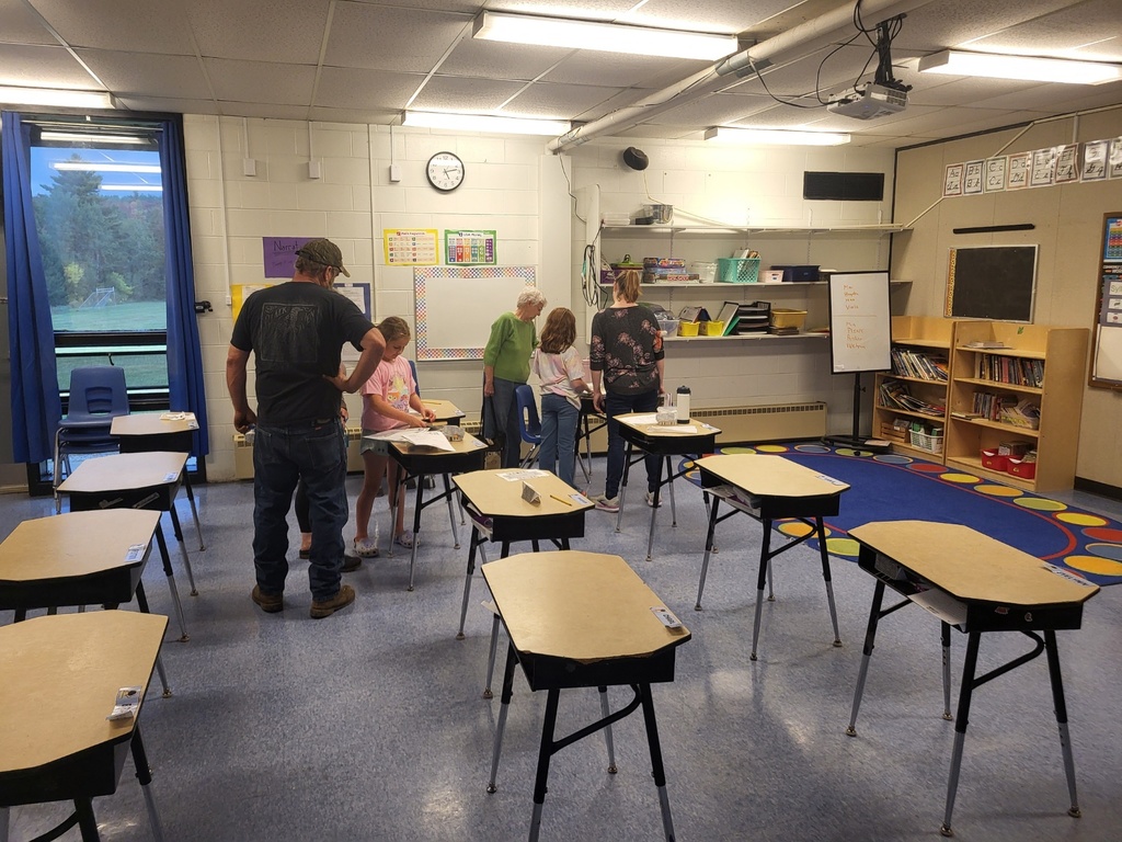 students and families reading at open house