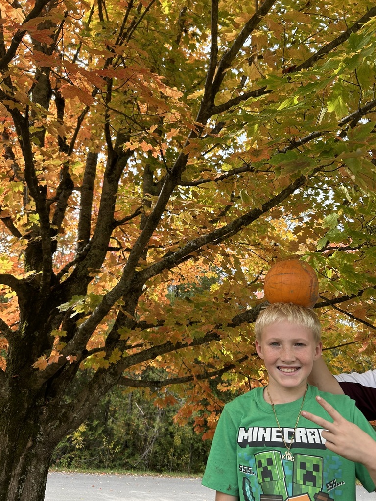 Student with a pumpkin on his head